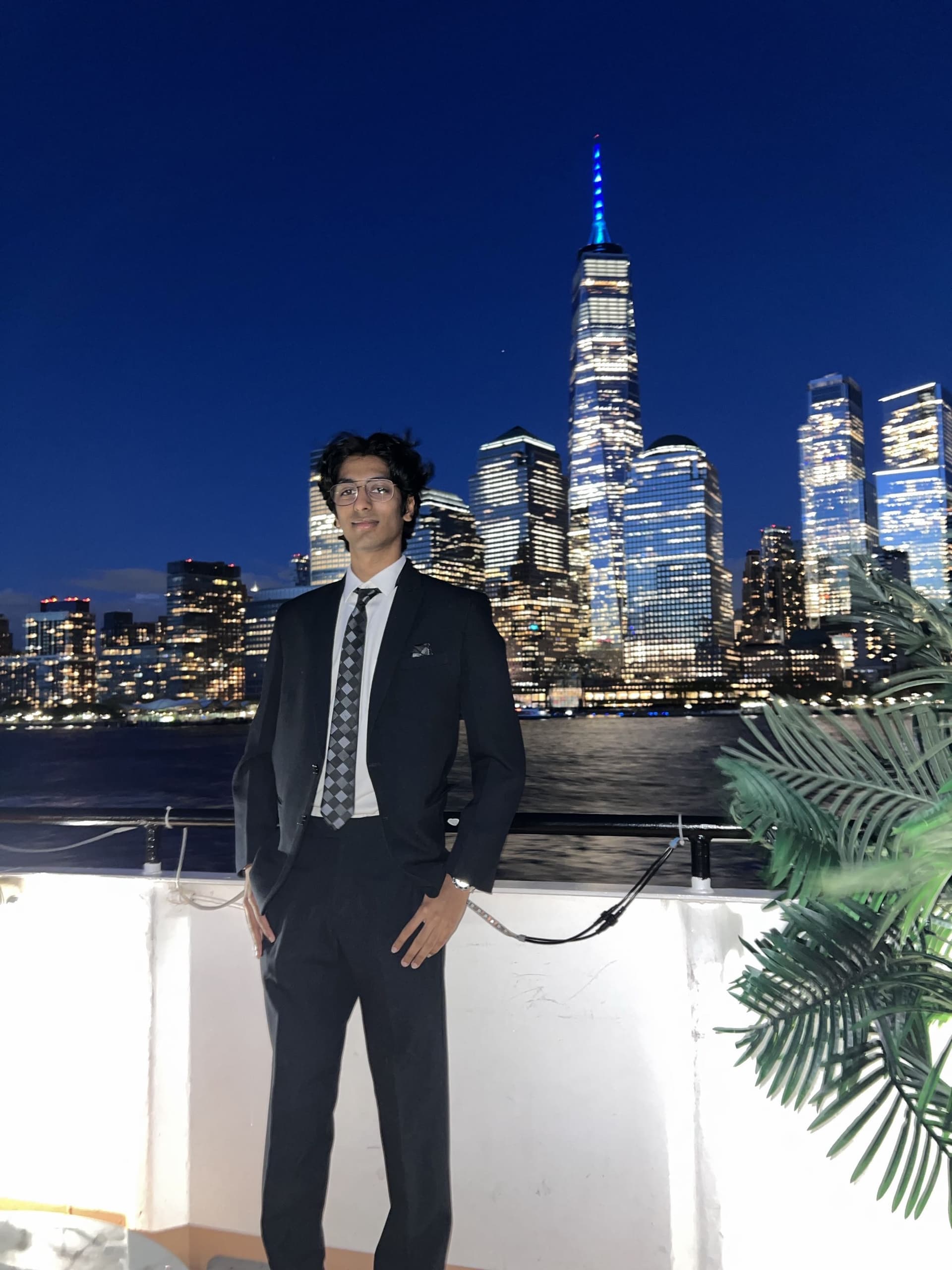 Hitaansh Jain in front of the lower Manhattan skyline at night